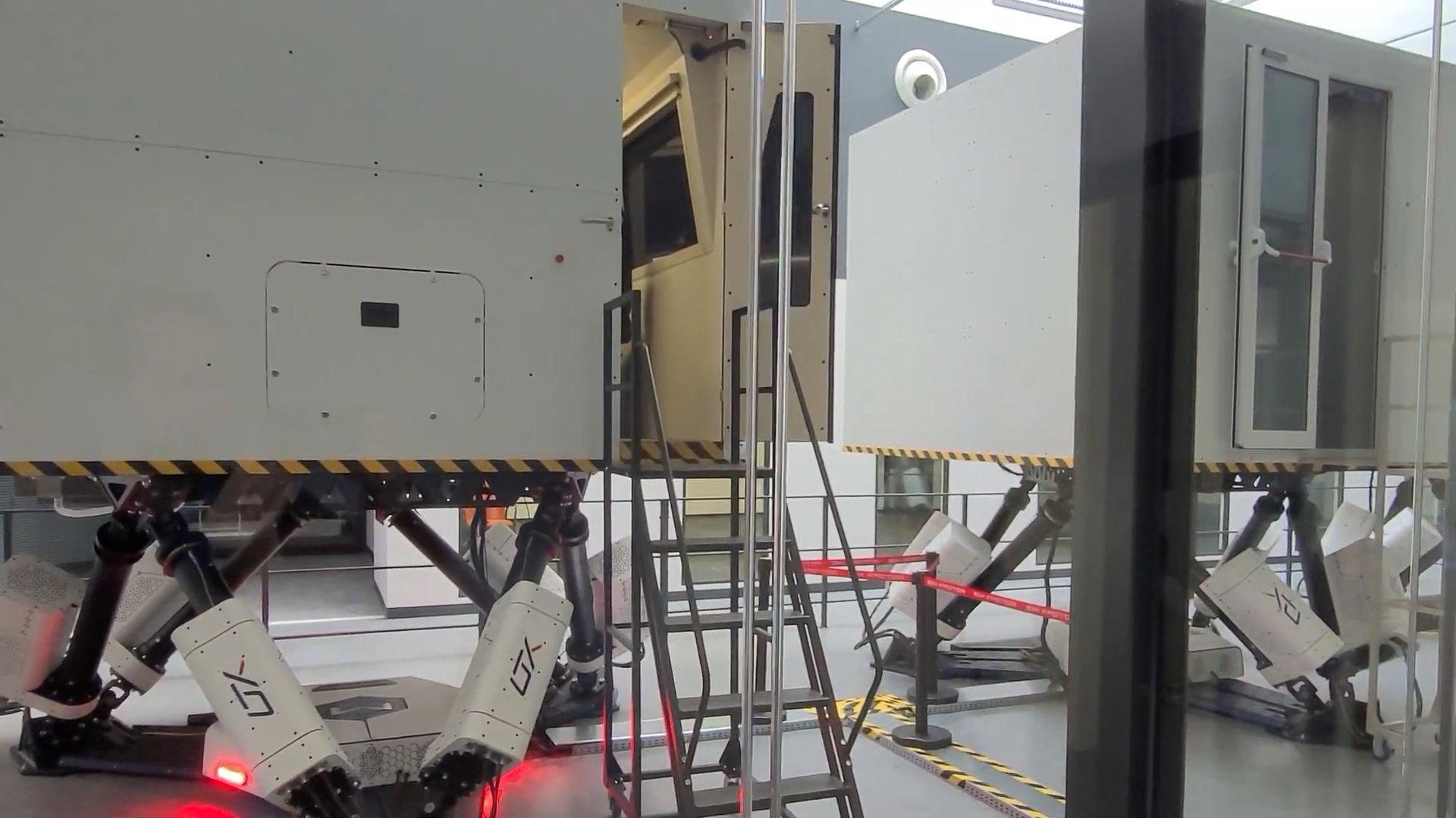 Full train cabin mounted on a 6DOF motion platform with boarding stairs